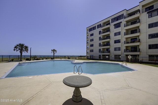 pool featuring a patio and fence