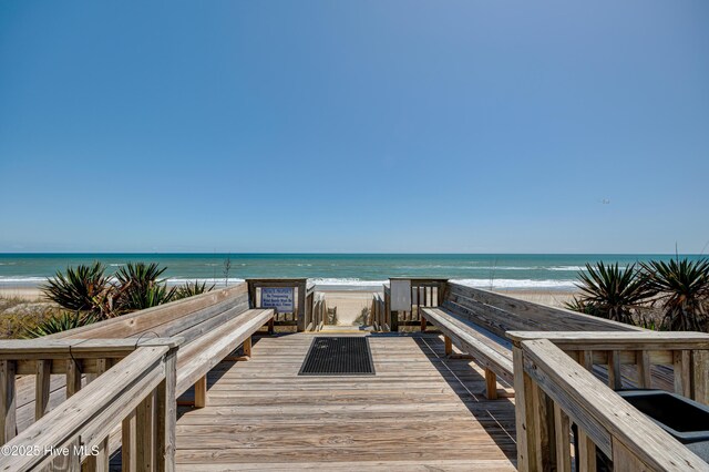 view of community with a beach view and a water view