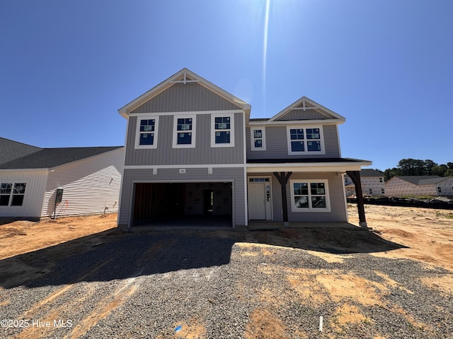 500 Grassy Gap Trl Unit 71, Aberdeen, NC 28315 - view of front of house featuring dirt driveway, an attached garage, and covered porch