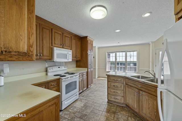 kitchen featuring recessed lighting, white appliances, light countertops, a textured ceiling, and brown cabinetry