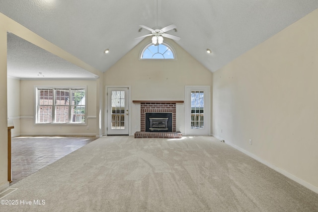 unfurnished living room with a fireplace, carpet flooring, baseboards, and ceiling fan
