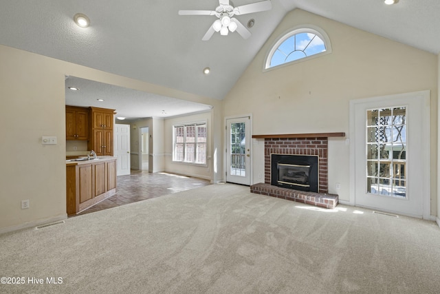 unfurnished living room with ceiling fan, light colored carpet, visible vents, recessed lighting, and baseboards