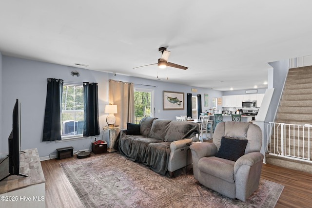 4333 Jones St SW, Shallotte, NC 28470 - living area featuring visible vents, baseboards, wood finished floors, ceiling fan, and stairway
