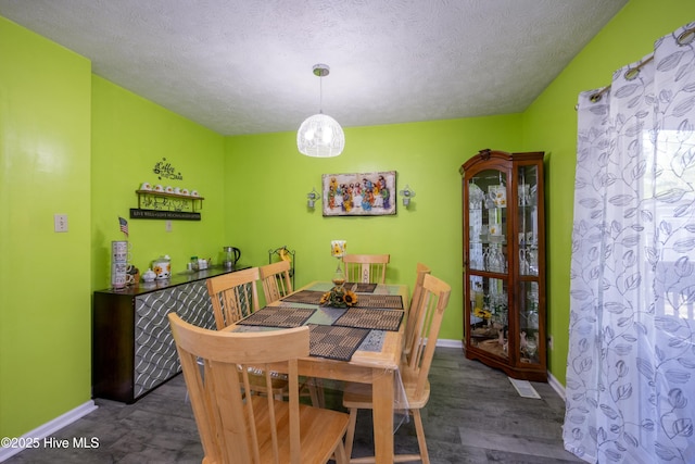 479 W 5th St, Garland, NC 28441 - dining space with baseboards, wood finished floors, and a textured ceiling
