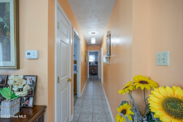 479 W 5th St, Garland, NC 28441 - hall with tile patterned floors, a textured ceiling, and baseboards