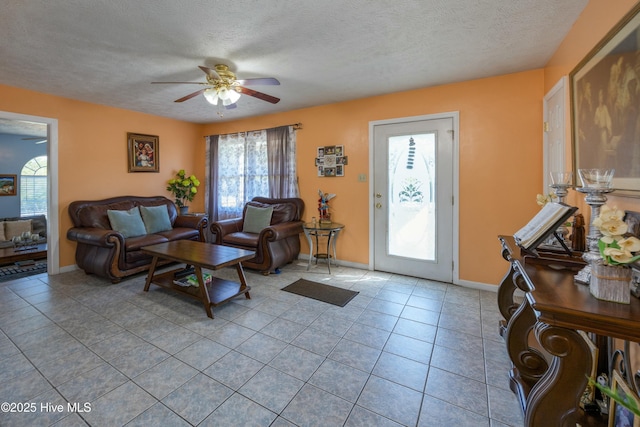 479 W 5th St, Garland, NC 28441 - living area featuring baseboards, light tile patterned floors, a textured ceiling, and a ceiling fan