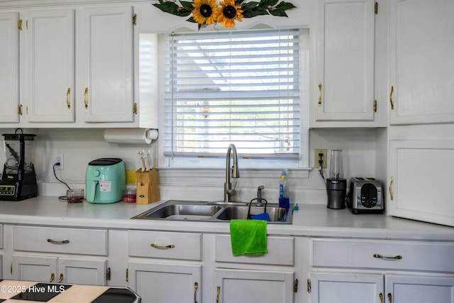 479 W 5th St, Garland, NC 28441 - kitchen featuring a sink, light countertops, and white cabinets
