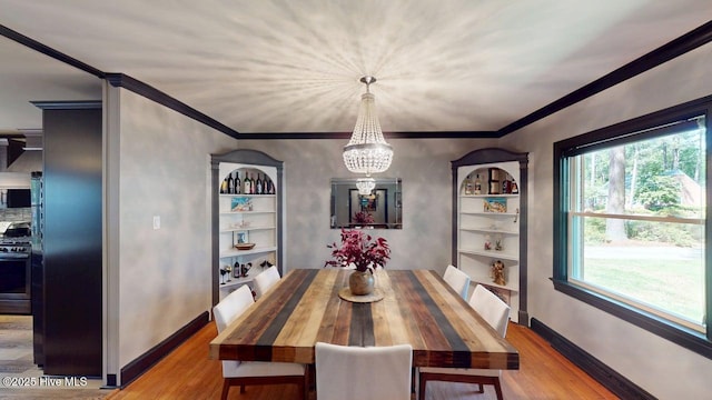 724 York St, Rocky Mount, NC 27803 - dining room featuring crown molding, wood finished floors, and an inviting chandelier
