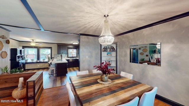 724 York St, Rocky Mount, NC 27803 - dining area with crown molding, ceiling fan with notable chandelier, and wood finished floors