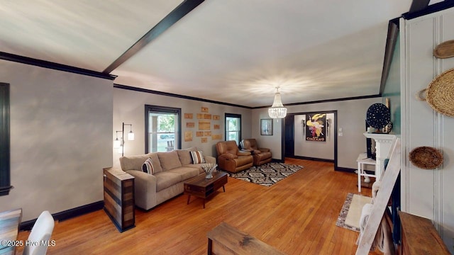 724 York St, Rocky Mount, NC 27803 - living area with crown molding, light wood finished floors, baseboards, and a chandelier