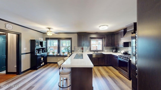 724 York St, Rocky Mount, NC 27803 - kitchen with a peninsula, a breakfast bar, stainless steel gas range oven, light countertops, and a sink