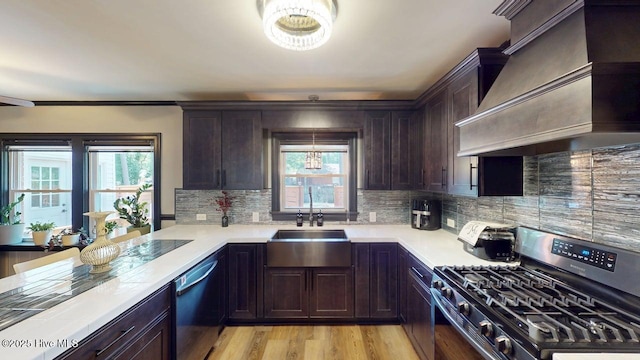 724 York St, Rocky Mount, NC 27803 - kitchen featuring light countertops, stainless steel gas range oven, backsplash, and custom exhaust hood