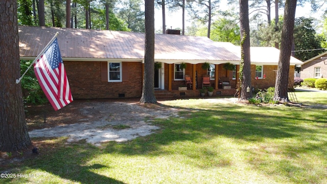 724 York St, Rocky Mount, NC 27803 - view of front of home with a porch, crawl space, metal roof, a front yard, and brick siding
