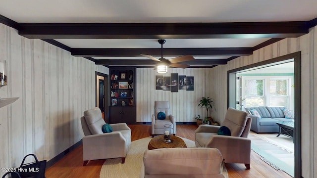 724 York St, Rocky Mount, NC 27803 - living area with a ceiling fan, wood finished floors, beam ceiling, and wallpapered walls