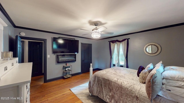 724 York St, Rocky Mount, NC 27803 - bedroom with crown molding, a ceiling fan, baseboards, and light wood-style floors