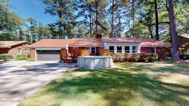 724 York St, Rocky Mount, NC 27803 - single story home with an attached garage, brick siding, driveway, and a chimney