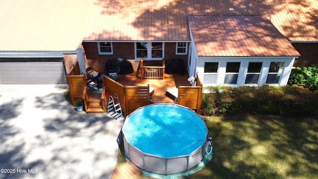 724 York St, Rocky Mount, NC 27803 - rear view of property with brick siding, a deck, metal roof, and a lawn