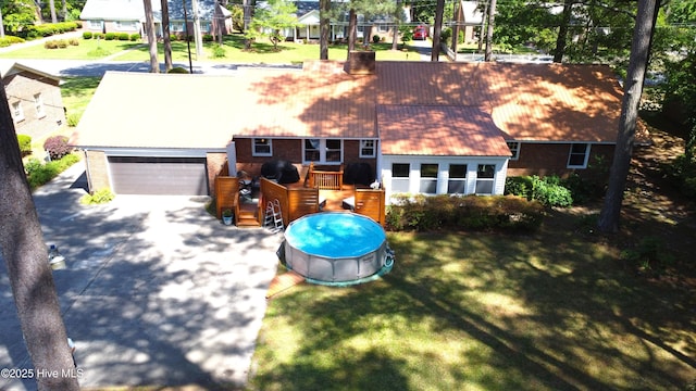 724 York St, Rocky Mount, NC 27803 - view of front facade with a chimney, a garage, brick siding, a front lawn, and concrete driveway