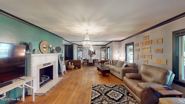 724 York St, Rocky Mount, NC 27803 - living area featuring a premium fireplace, a chandelier, ornamental molding, and light wood-style floors