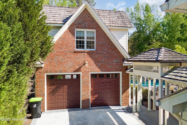 view of front of home featuring brick siding, driveway, and a garage