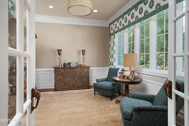 living area with a decorative wall, ornamental molding, a wainscoted wall, and recessed lighting