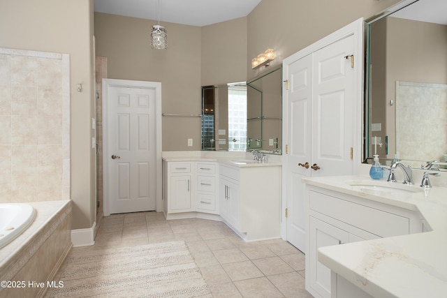 full bathroom featuring a garden tub, tile patterned floors, a sink, a stall shower, and two vanities