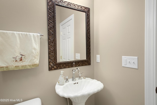 half bath with a sink and toilet