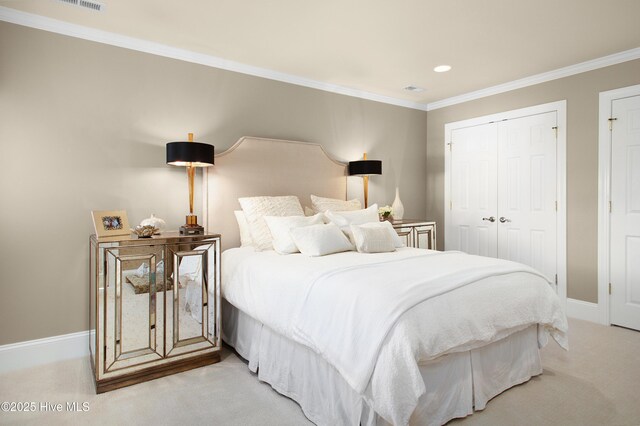 bedroom featuring recessed lighting, a closet, ornamental molding, and light carpet