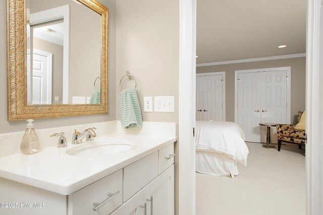 bathroom with crown molding, vanity, and ensuite bathroom