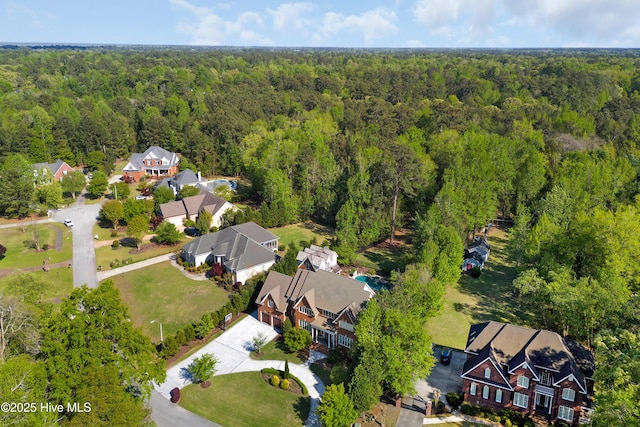 aerial view featuring a residential view and a wooded view