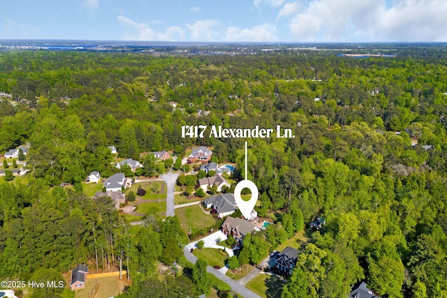 drone / aerial view featuring a forest view