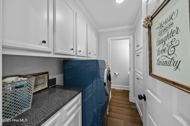 laundry area featuring separate washer and dryer, ornamental molding, cabinet space, and dark wood-style floors