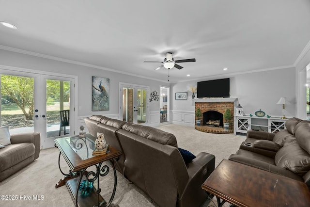 living area featuring light carpet, french doors, ceiling fan, and a decorative wall