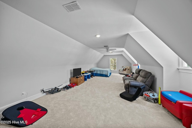 playroom with carpet, visible vents, vaulted ceiling, and ceiling fan