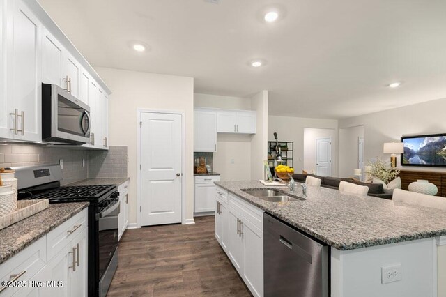3048 Platinum Cir W, End, NC 27376 - kitchen featuring dark wood-type flooring, white cabinetry, appliances with stainless steel finishes, light stone counters, and a sink