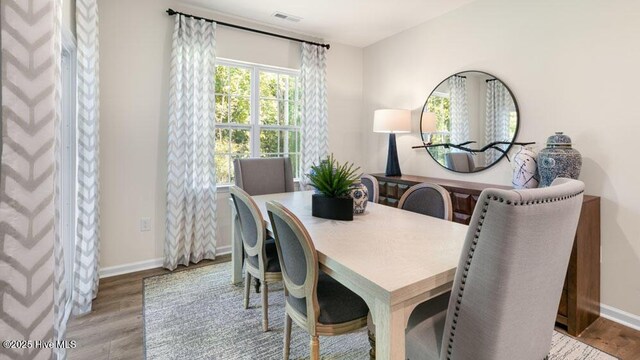 3048 Platinum Cir W, End, NC 27376 - dining room featuring light wood-type flooring, baseboards, and visible vents