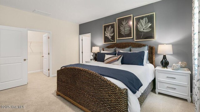 3048 Platinum Cir W, End, NC 27376 - bedroom featuring light carpet and a walk in closet