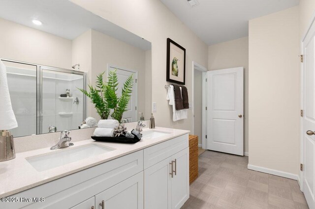 3048 Platinum Cir W, End, NC 27376 - full bath featuring a sink, baseboards, a shower stall, and double vanity