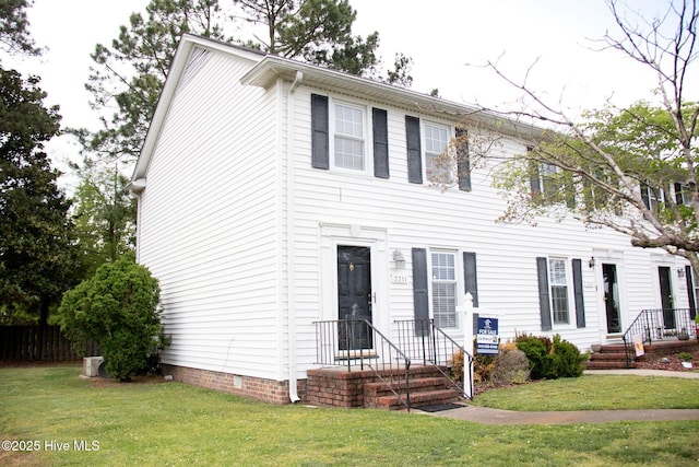 colonial inspired home with a front yard and crawl space