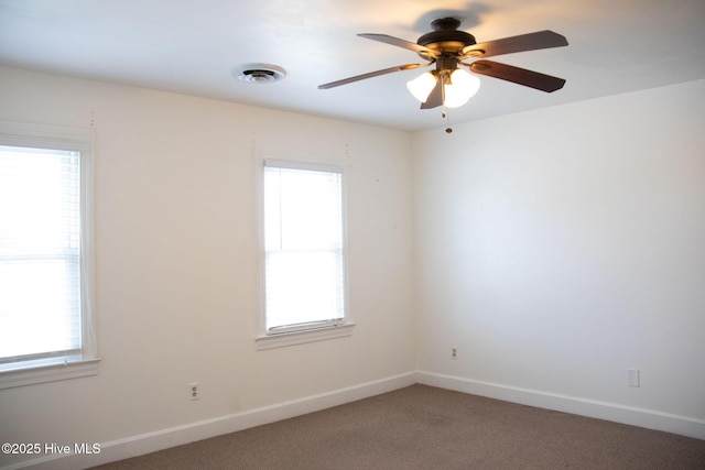 empty room featuring visible vents, baseboards, a ceiling fan, and carpet