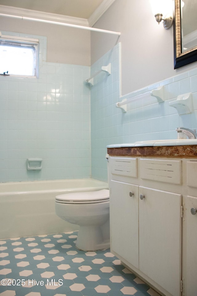 full bathroom with washtub / shower combination, vanity, tile patterned floors, toilet, and tile walls