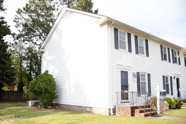 exterior space with crawl space, ac unit, a front yard, and fence