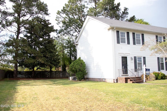 exterior space with crawl space, fence, and a front lawn