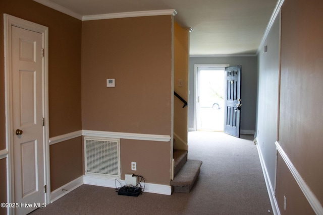hall with crown molding, visible vents, baseboards, and carpet flooring