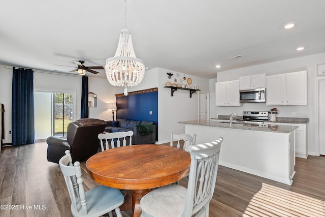 1524 Pleasant Hollow Ct SE, Bolivia, NC 28422 - dining area featuring recessed lighting, ceiling fan with notable chandelier, baseboards, and wood finished floors