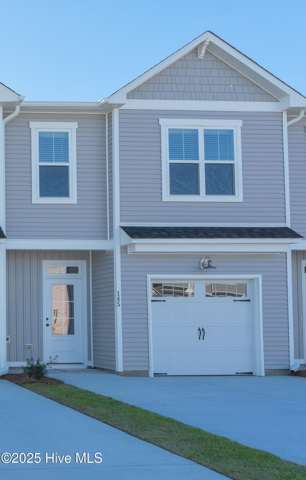 136 Jansen Ln, Winnabow, NC 28479 - view of front of house featuring a garage and driveway