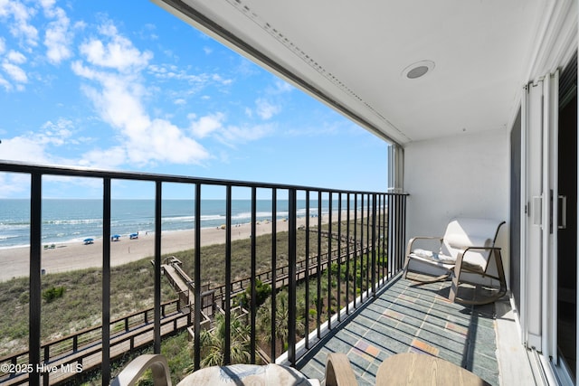 balcony with view of water and beach
