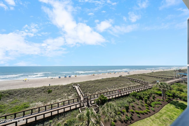 water view featuring nearby beach and fence