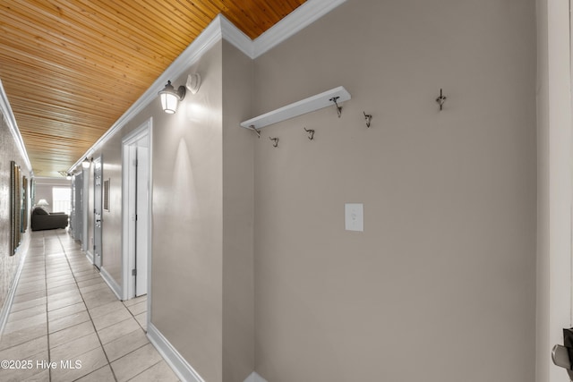 hall featuring wooden ceiling, crown molding, light tile patterned floors, and baseboards