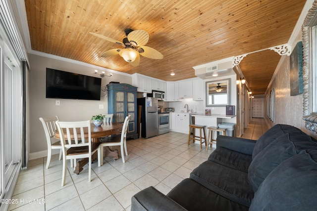 living room with a ceiling fan, wooden ceiling, light tile patterned floors, crown molding, and baseboards